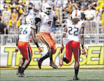  ?? STREETER LECKA / GETTY IMAGES ?? Hurricanes players celebrate after a play against Appalachia­n State on Sept. 17. SB Nation says the Hurricanes are more than 50 percent likely to win all of their remaining games.