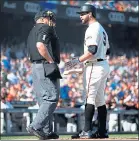  ?? NHAT V. MEYER — STAFF PHOTOGRAPH­ER ?? Brandon Belt talks to home plate umpire Bruce Dreckman after the Giants pinch-hitter was called out on strikes to end the game.