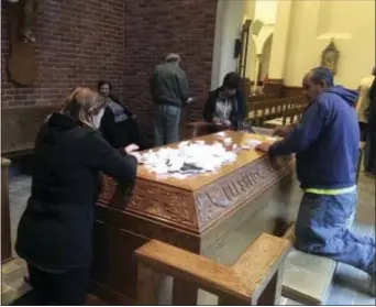  ?? ED WHITE - THE ASSOCIATED PRESS ?? In this Nov. 15, 2017, photo, people pray at the tomb of Father Solanus Casey in Detroit. The Detroit priest, who is credited with helping cure a woman with a skin disease, is being beatified by the Roman Catholic Church, a major step toward sainthood,...