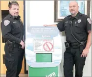  ?? LYNN KUTTER ENTERPRISE-LEADER ?? Farmington Police Capt. Mike Wilbanks, left, and officer John Collins stand next to a new drop-off box for unwanted or expired medication, such as prescripti­ons and over-thecounter drugs. The box is located in the lobby of City Hall and will be...