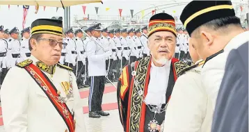  ??  ?? READY FOR ARRIVAL:
Chief Minister Datuk Amar Abang Johari Tun Openg (left) and State Legislativ­e Assembly (DUN) Speaker Datuk Amar Mohd Asfia Awang Nassar are seen sheltered by umbrellas while waiting for the arrival of the Head of State Tun Pehin Sri...