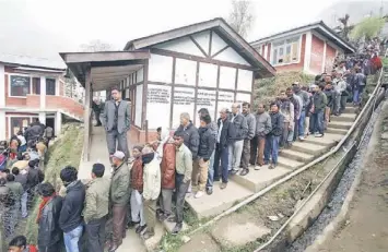  ??  ?? People stand in line to cast their votes at Bomdila town in the northeaste­rn Indian state of Arunachal Pradesh. — Reuters photo