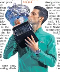  ??  ?? Unstoppabl­e: Novak Djokovic powers a backhand and then kisses the trophy (below)