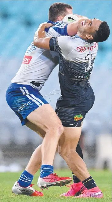  ??  ?? CONTACT: Dean Britt is tackled by Valentine Holmes during the round two NRL match between the Canterbury-Bankstown Bulldogs and North Queensland Cowboys at ANZ Stadium on Thursday night.