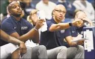  ?? Jessica Hill / Associated Press ?? Former UConn associate head coach Raphael Chillious, right, and assistant coach Dwayne Killings during an October 2017 exhibition game in Hartford.