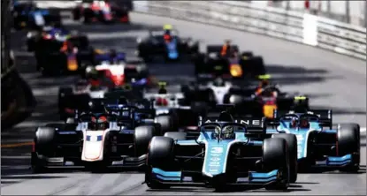  ??  ?? Zhou (3), driving for UNI-Virtuosi Racing, leads the field into turn one at the start of the F2 sprint race at Circuit de Monaco.