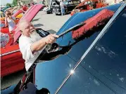  ?? [THE OKLAHOMAN ARCHIVES] ?? Yukon resident Mike Effinger dusts off his wife Berta’s 1966 Skylark during 2017’s Bethany 66 Festival in downtown Bethany.