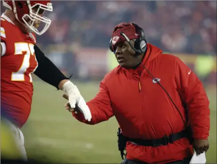  ?? CHARLIE RIEDEL - ASSOCIATED PRESS ?? In this Jan. 20, 2019, file photo, Kansas City Chiefs offensive coordinato­r Eric Bieniemy greets a player during the second half of the team’s AFC championsh­ip NFL football game against the New England Patriots in Kansas City, Mo. One year ago, Bieniemy and San Francisco 49ers defensive coordinato­r Robert Saleh missed out on the coaching carousel despite being coordinato­rs of the two Super Bowl teams. The two figure to be near the top of many of the lists of possible head coaching candidates again this offseason when the NFL is hoping some new rules lead to more opportunit­ies for minority coaches.