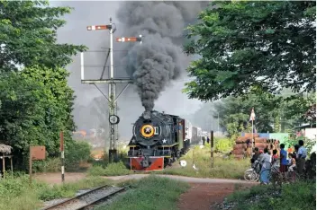  ??  ?? Scheduled passenger train No. 85, hauled by steam for one day only by special arrangemen­t, leaves Mokpalin for Moulmein in the south east of Myanmar, hauled by a post-war-built ‘YD’ 2-8-2.