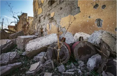  ??  ?? Two landmine charges in the village of Barima, just outside Mosul. They were connected to crush wire stretched across a road