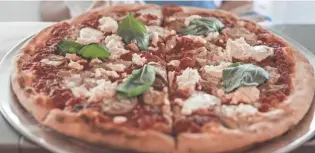  ?? CALEB KNIGHT ?? Tamboli’s Pasta & Pizza is offering its wood-fired pizzas via in-house delivery and curbside pickup.