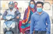  ?? YOGENDRA KUMAR/HT PHOTO ?? ■
People seen wearing protective masks in Gurugram on Monday.