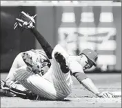  ?? Jim McIsaac
Getty Images ?? MIKE TROUT of the Angels tries to advance to second base on a f lyout but is tagged out by New York Yankees shortstop Didi Gregorius in the third inning.