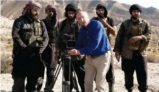  ??  ?? British filmmaker Peter Kosminsky prepares to film on the set of ‘The State.’ (Photo courtesy of Channel 4)
