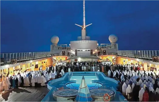  ??  ?? Evening prayers on the deck of the Italian-owned Costa Victoria. More than 1,000 Muslims from 12 nationalit­ies went on the voyage across the Malacca Strait last week.— Photos: ANN