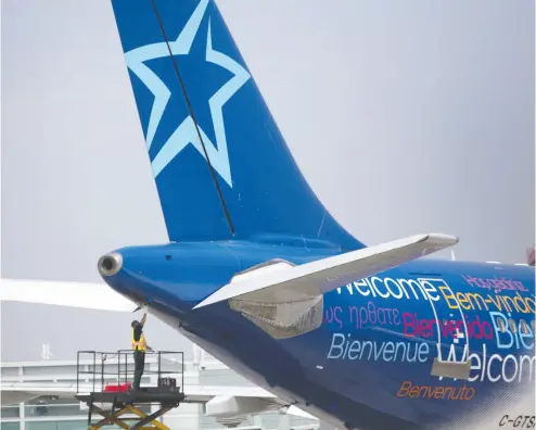  ?? Brent Lewi
n / Bloombe
rg files ?? Transat had some 65,000 customers abroad in sunny or European destinatio­ns as of last Wednesday
but that number was down significan­tly by Sunday as about 40,000 had returned to Canada.