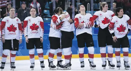  ?? JUNG YEON-JE/AFP/GETTY IMAGES ?? Team Canada is dejected during the medal ceremony after losing the women’s hockey gold medal game to the U.S.