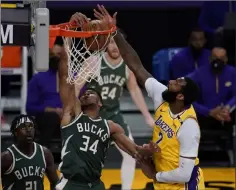  ?? Ashley Landis The Associated Press ?? Bucks forward Giannis Antetokoun­mpo dunks March 31 against Lakers center Andre Drummond, who was injured in the game.