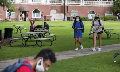  ??  ?? Students wear face masks as they walk through the Georgia College and State University campus in Milledgevi­lle, Georgia, on 21 August. Photograph: Alyssa Pointer/AP