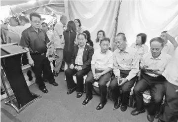  ??  ?? (Seated front from left) Wong, Dr Sim, and Tiong are seen at the memorial.