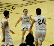  ?? Buy these photos at YumaSun.com PHOTOS BY WARNER STRAUSBAUG­H/YUMA SUN ?? TOP: A CIBOLA FAN (LEFT) RUNS ON THE COURT to celebrate with Ivan Galindo after Galindo made a tiebreakin­g, buzzerbeat­ing 3-pointer to give the Raiders a 64-61 win against Kofa on Tuesday at Cibola. ABOVE: Ryan Curtis-Sanchez (10) and CJ Atherton...