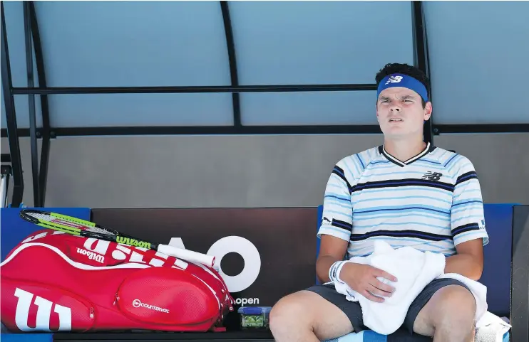  ?? — GETTY IMAGES ?? Milos Raonic rests after a game against Lukas Lacko in their first-round match Tuesday at the Australian Open in Melbourne, Australia. Raonic lost the match.