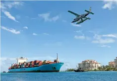  ?? AP Photo/Wilfredo Lee ?? ■ A Tropic Ocean Airways seaplane flies over the Gerd Maersk as the container ship heads to Port Miami on May 5 in Miami Beach, Fla. On Wednesday, the Labor Department issued revised data on productivi­ty in the first quarter.