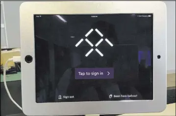  ??  ?? Faraday Future visitors and guests use an iPad to sign in at the main facility in Gardena, Calif. The process includes signing a “Recruitmen­t Confidenti­ality and Non-Disclosure Agreement.”