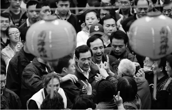  ?? (Jason Lee/reuters) ?? SUPPORTERS gesture to Taiwan’s President and Nationalis­t Party (KMT) presidenti­al candidate Ma Ying-jeou (center) at a temple during a campaign rally for the 2012 presidenti­al election in Xinbei city, northern Taiwan, last week. The election will be...