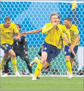  ?? DARKO BANDIC — THE ASSOCIATED PRESS ?? Emil Forsberg, front, celebrates with teammates after scoring the only goal in Sweden’s 1-0 win over Switzerlan­d in the World Cup round of 16on Tuesday in Russia.