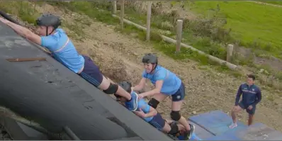  ??  ?? The Mahoneys climbing one of the final obstacles, watched on by Wexford hurler Lee Chin.