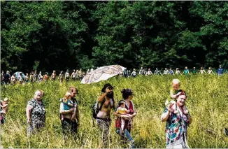  ?? PHOTOS CONTRIBUTE­D BY CYNTHIA HERMS ?? People gather in a field at the Rainbow Family of Living Light Gathering, which took place for the first time ever in Georgia earlier this month at Chattahooc­hee National Forest.