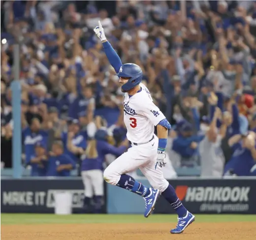  ?? GETTY IMAGES ?? The Dodgers’ Chris Taylor celebrates his walk-off two-run home run in the ninth inning against the Cardinals in the National League wild-card game.