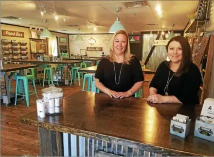  ?? DONNA ROVINS — DIGITAL FIRST MEDIA ?? AR Workshop is a DIY studio at 1810 Swamp Pike in New Hanover where customers can make home decor items from wood or canvas. Shown here are owners Kelly Elliott, left, and Michelle Shilling. The studio officially opens May 19 with an open house from 6...
