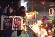  ?? Associated Press ?? People gather at a candleligh­t vigil last weekend in California following the shootings at Atlanta-area massage parlors.