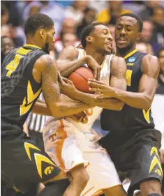  ?? RICK OSENTOSKI, USA TODAY SPORTS ?? Tennessee’s Jordan McRae, center, battles for control of the ball Wednesday. He scored a game-high 20 points.