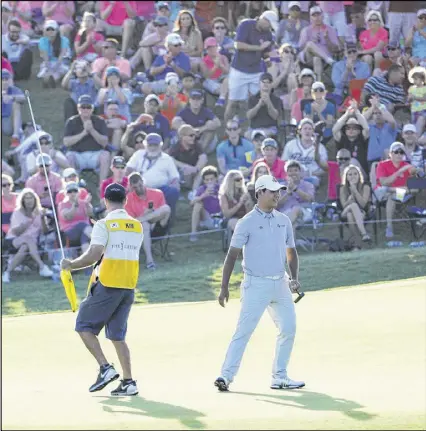  ?? JAMIE SQUIRE / GETTY IMAGES ?? Si Woo Kim celebrates his three-shot victory on the 18th green during Sunday’s final round of The Players Championsh­ip. The 21-year-old Korean became the youngest Players champion in the tournament’s history, besting Adam Scott’s 2004 win by two years.