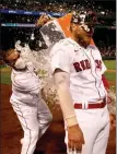  ?? Getty imaGes ?? alex Verdugo is doused with water by christian Vazquez after driving in the winning run against the cleveland indians on saturday.
