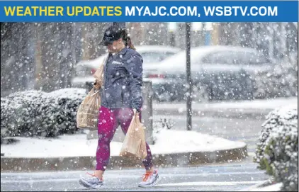  ?? BRANT SANDERLIN / BSANDERLIN@AJC.COM ?? Shoppers, including this woman in Canton, rush to grocery stores to pick up last-minute supplies in advance of a winter storm that was forecast as this year’s scariest.