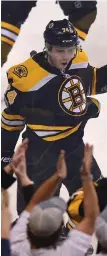  ?? STAFF PHOTO BY CHRISTOPHE­R EVANS ?? NIGHT TO REMEMBER: Jake DeBrusk celebrates in front of the Garden fans after scoring a goal in his NHL debut as the Bruins beat the Predators, 4-3.