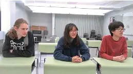  ?? The Sentinel-Record/Lance Porter ?? ■ Arkansas School for Mathematic­s, Sciences, and the Arts junior Avery Binuya, center, talks about the debate team’s journey to earning charter status on Wednesday, as teammates Linden Mixon, left, and Kuhno Lee look on.