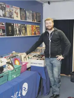  ??  ?? HERE TO HELP: Retail support assistant Brandon Love by the vinyl section in the Brighouse shop.