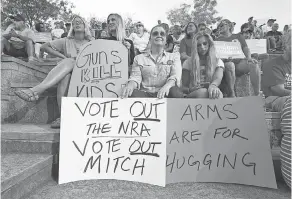  ?? SAM UPSHAW JR./USA TODAY NETWORK ?? Kirsten Mack, center, attends a rally for gun control with her daughters, Ani, 17, and Lilly, 19, and their friend Mary Grothaus, 19, on Friday outside the Muhammad Ali Center in Louisville, Ky.