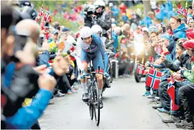  ??  ?? Norse power: Chris Froome is cheered by Norwegian fans at the world road race