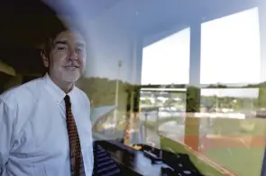  ?? JONATHON GRUENKE/STAFF ?? Peninsula Pilots broadcaste­r Frank Edgar stands inside the press box above War Memorial Stadium before the start of Tuesday’s game in Hampton.