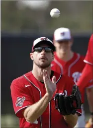  ?? JEFF ROBERSON ?? Washington Nationals pitcher Max Scherzer catches a popup during a spring training baseball drill Friday, Feb. 14, 2020, in West Palm Beach, Fla.