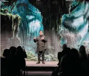  ?? Markus Schreiber/associated Press ?? Media artist Refik Anadol stands by an image generated by his “Large Nature Model” AI during a discussion Thursday at the World Economic Forum.