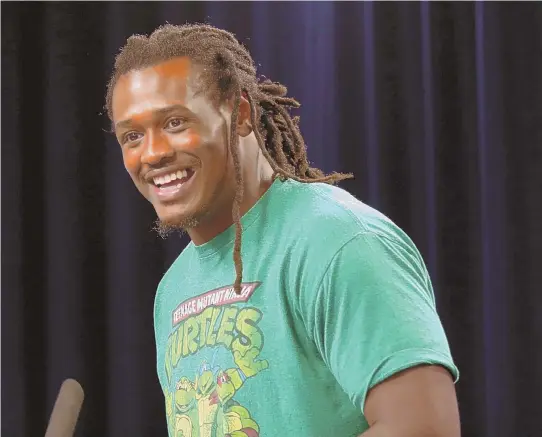  ?? STAFF PHOTO BY JOHN WILCOX ?? DISPLAYING PLENTY OF CHARACTER: Dont’a Hightower wears a Teenage Mutant Ninja Turtles T-shirt yesterday as he meets the media at Gillette Stadium, talking about his role as a leader and a versatile player in the Patriots defense.