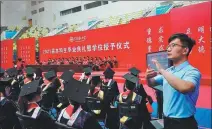 ?? ZENG XIYING / FOR CHINA DAILY ?? Wang Xiaoou gives sign language interpreta­tion for graduates from the Technical College for the Deaf at the Tianjin University of Technology on June 24.