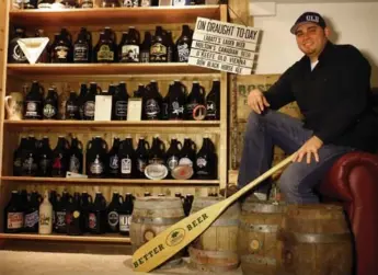  ?? COLE BURSTON/TORONTO STAR ?? Troy Burtch at home with part of his breweriana collection. Burtch estimates he has 400 items in his collection.